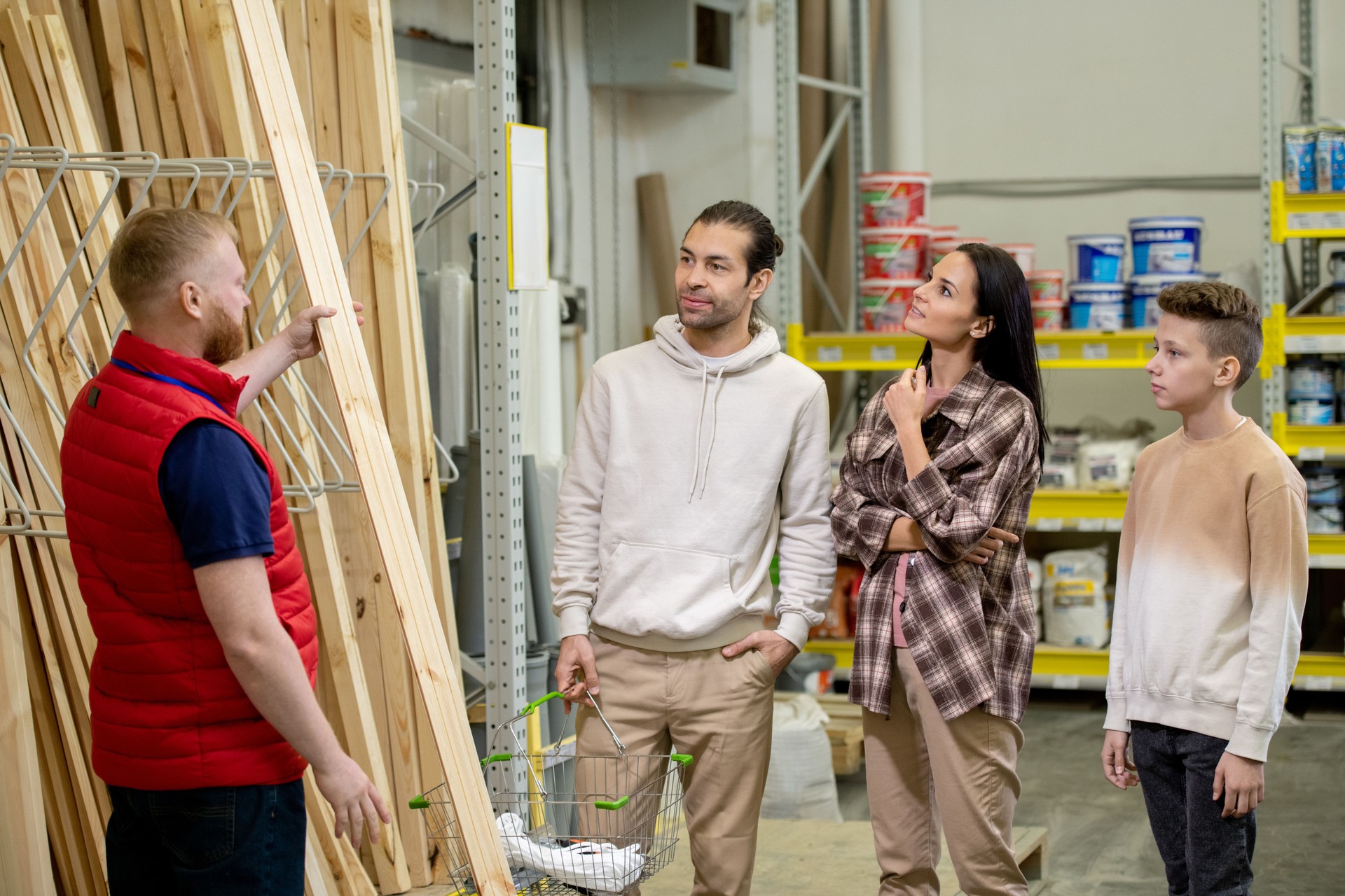 Sales manager helping customers choose wooden planks
